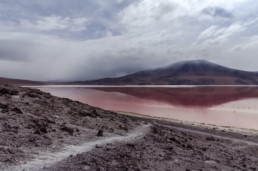 Red lake, one mountain, cloudy sky